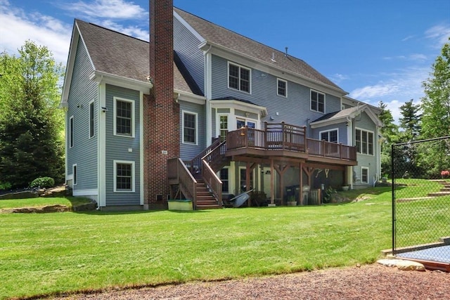 52 Sylvan Dr, Stow, MA 01775 - back of house with stairs, a deck, a chimney, a lawn, and roof with shingles