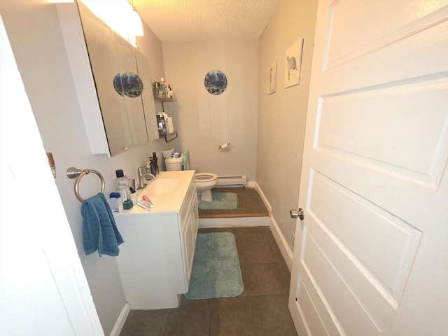 133 Mount Vernon St, Lowell, MA 01854 - bathroom featuring baseboard heating, a textured ceiling, vanity, toilet, and tile patterned floors