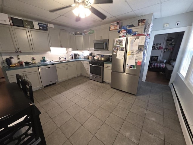 133 Mount Vernon St, Lowell, MA 01854 - kitchen featuring stainless steel appliances, a baseboard heating unit, a sink, tasteful backsplash, and a ceiling fan