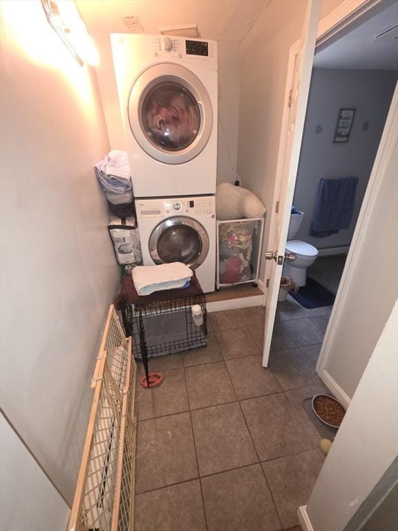 133 Mount Vernon St, Lowell, MA 01854 - laundry area with stacked washing machine and dryer and tile patterned flooring