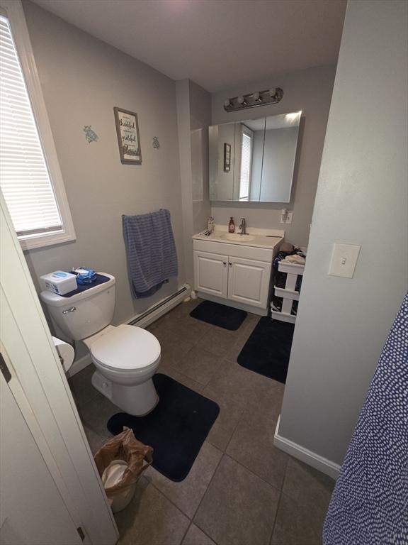 133 Mount Vernon St, Lowell, MA 01854 - bathroom featuring baseboard heating, tile patterned flooring, toilet, and vanity