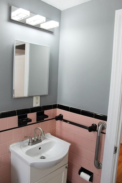 bathroom with vanity, tile walls, and wainscoting