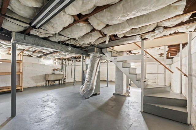 unfinished below grade area with stairs and a sink