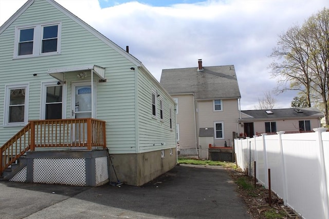 back of house featuring fence