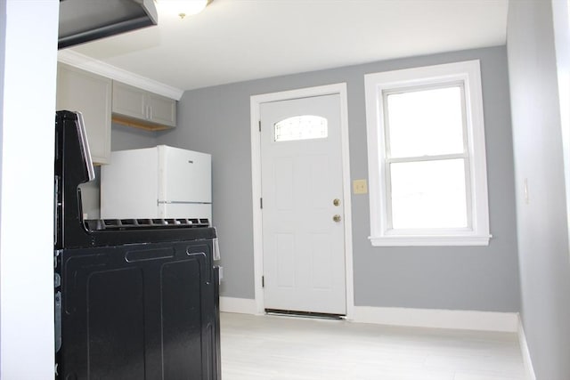 interior space with baseboards and light wood-style floors