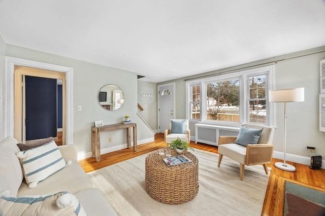 living room with radiator heating unit and light wood-type flooring