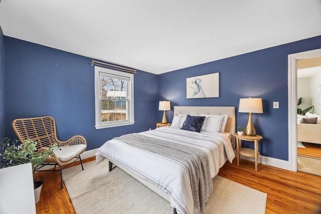 bedroom with hardwood / wood-style floors