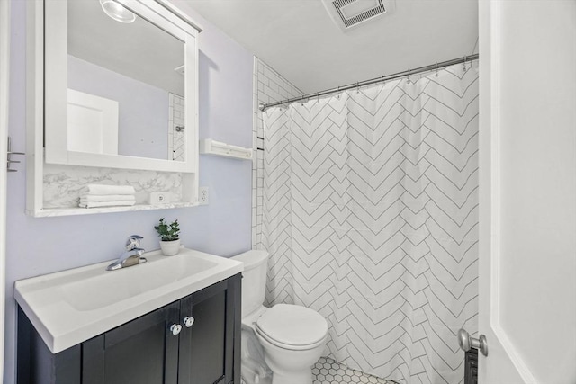 bathroom featuring vanity, walk in shower, and toilet