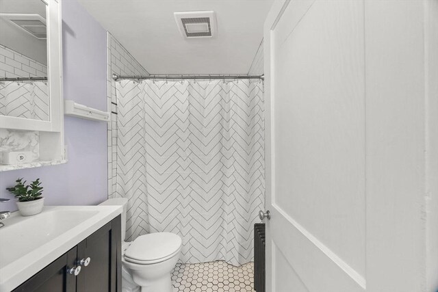 bathroom with vanity, toilet, and tile patterned flooring