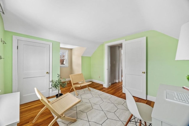sitting room featuring hardwood / wood-style flooring and lofted ceiling