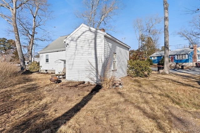 view of home's exterior with a yard