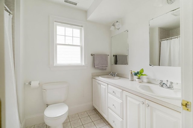 full bathroom featuring baseboards, toilet, and double vanity