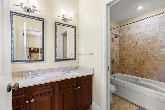 full bathroom with double vanity, toilet, shower / bath combination, and a sink