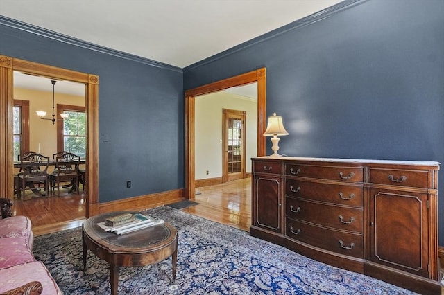 47 Stetson, Haverhill, MA 01835 - living room with light wood finished floors, a chandelier, baseboards, and crown molding