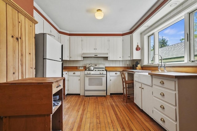 47 Stetson, Haverhill, MA 01835 - kitchen featuring white appliances, under cabinet range hood, a sink, and healthy amount of natural light
