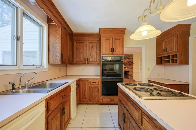 kitchen featuring sink, stovetop, dishwasher, pendant lighting, and black double oven