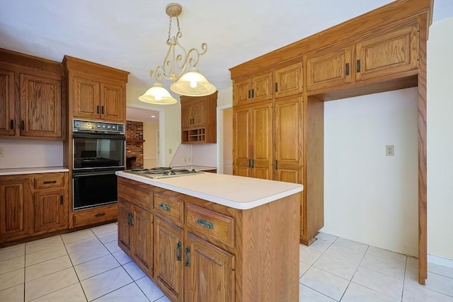 kitchen with light tile patterned floors, double oven, hanging light fixtures, a kitchen island, and stainless steel gas stovetop