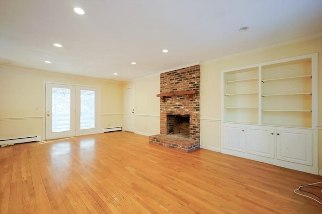 unfurnished living room with crown molding, baseboard heating, a fireplace, light hardwood / wood-style floors, and built in shelves