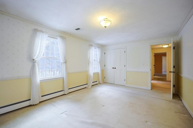 unfurnished bedroom with crown molding, light carpet, and a closet