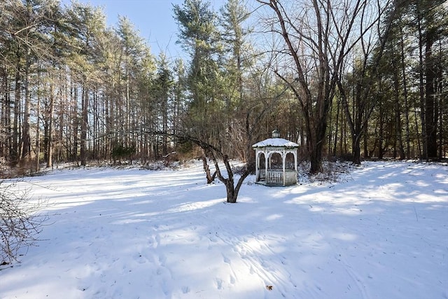 yard layered in snow with a gazebo