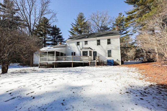 snow covered house featuring a deck