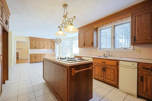 kitchen with a kitchen island, sink, pendant lighting, and light tile patterned floors