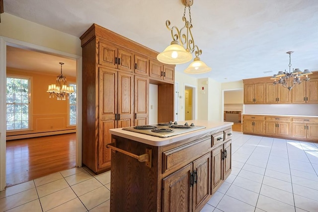 kitchen featuring an inviting chandelier, decorative light fixtures, white electric stovetop, and a kitchen island