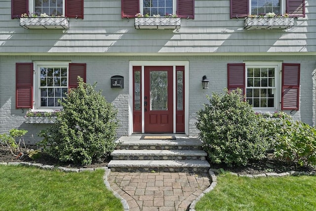 view of exterior entry with brick siding