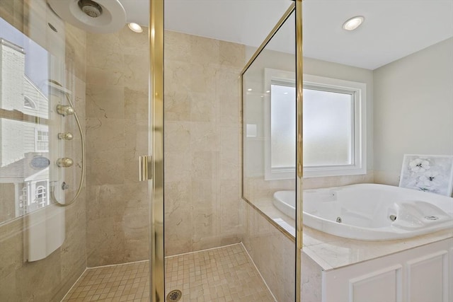 bathroom with a whirlpool tub and a stall shower