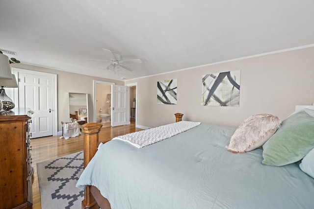 bedroom with baseboards, ornamental molding, ceiling fan, and wood finished floors