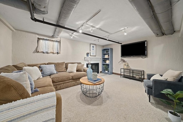 living room with carpet floors and a glass covered fireplace