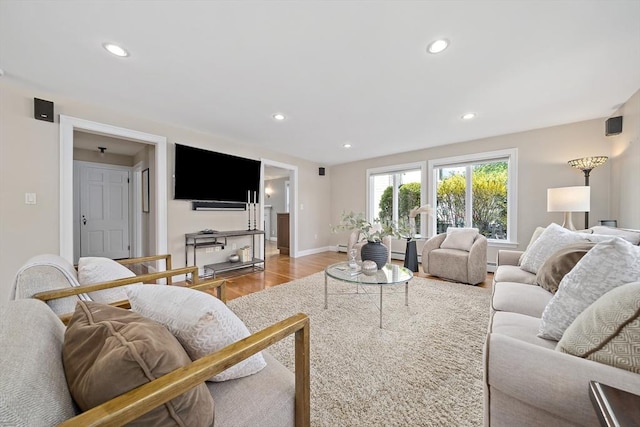 living area featuring recessed lighting, baseboards, and wood finished floors