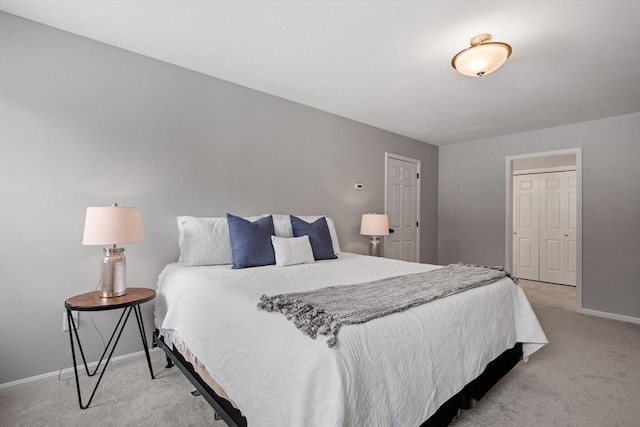 bedroom with light colored carpet and baseboards