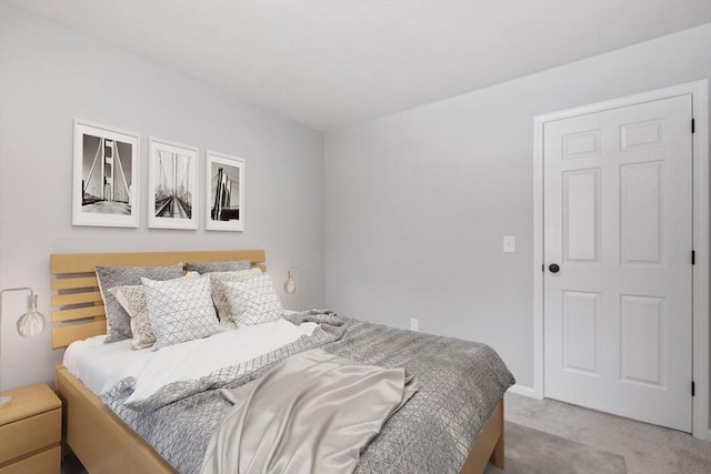 bedroom featuring light colored carpet and baseboards