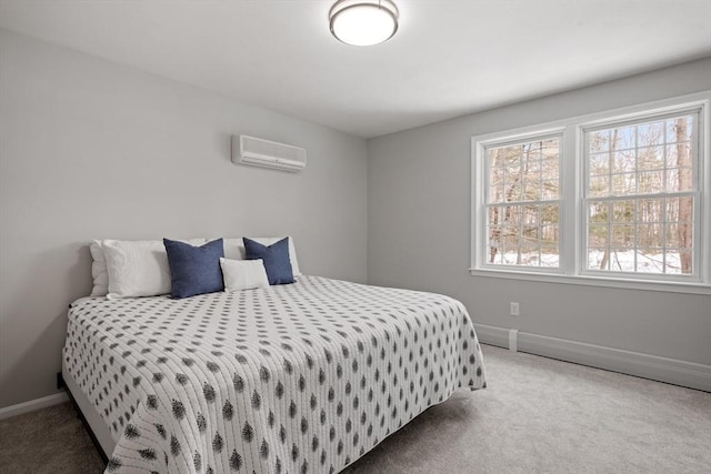 bedroom featuring a wall unit AC, carpet flooring, and baseboards