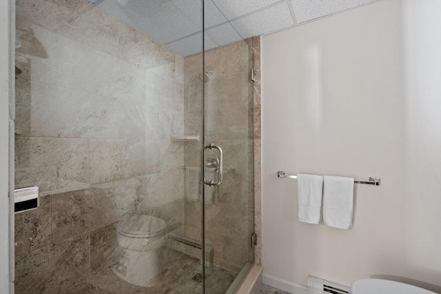 full bath featuring toilet, a stall shower, and baseboard heating