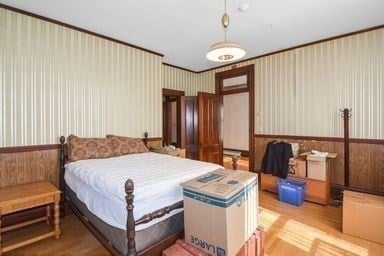 bedroom featuring light wood-type flooring and ornamental molding