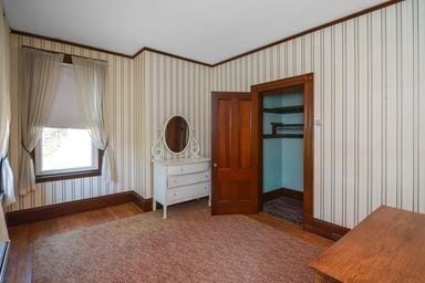 unfurnished bedroom featuring crown molding