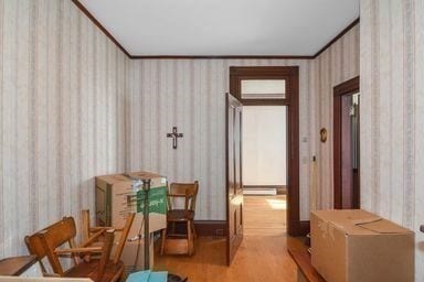 interior space with crown molding and light hardwood / wood-style floors