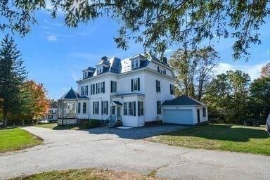 32 Mount Pleasant St, North Brookfield, MA 01535 - view of front of house with a garage, aphalt driveway, and a front lawn