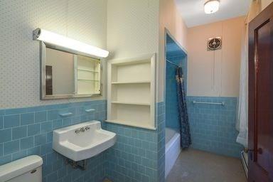 32 Mount Pleasant St, North Brookfield, MA 01535 - full bathroom featuring a wainscoted wall, toilet, shower / bath combo, a sink, and tile walls