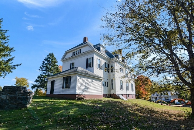 view of home's exterior with a yard