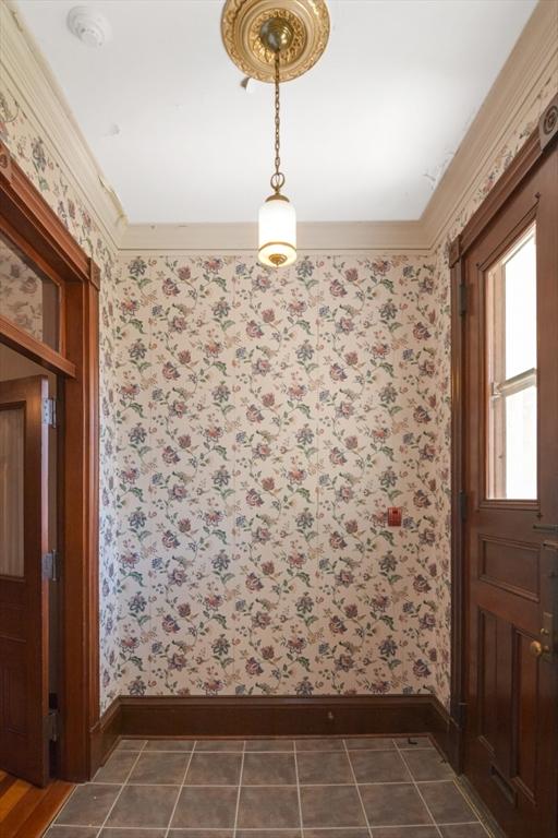 32 Mount Pleasant St, North Brookfield, MA 01535 - unfurnished dining area featuring ornamental molding, baseboards, and wallpapered walls