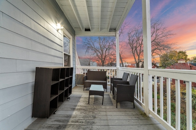 deck at dusk featuring outdoor lounge area