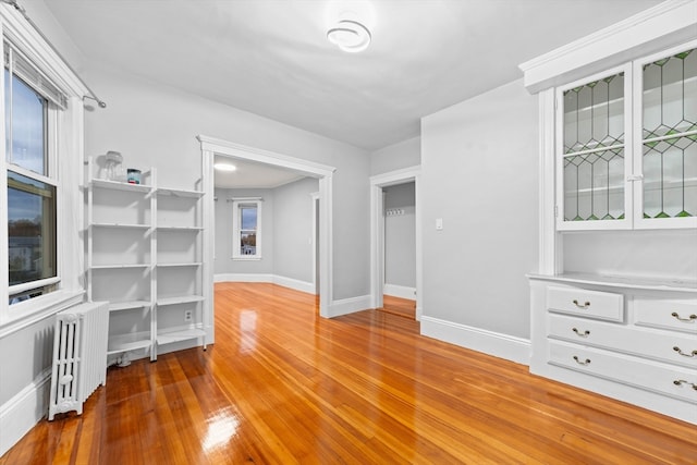 spare room with radiator and hardwood / wood-style flooring