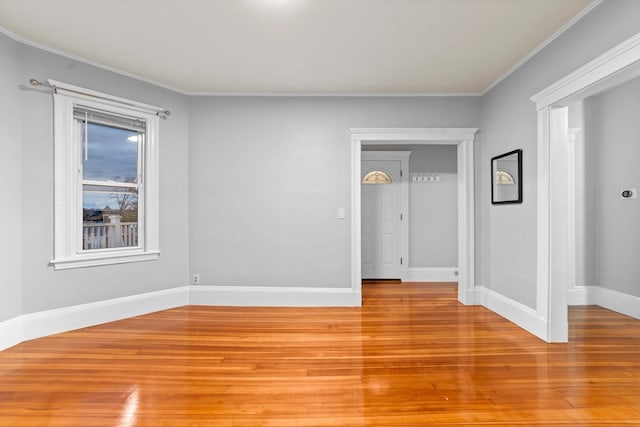 unfurnished room featuring light wood-type flooring and ornamental molding