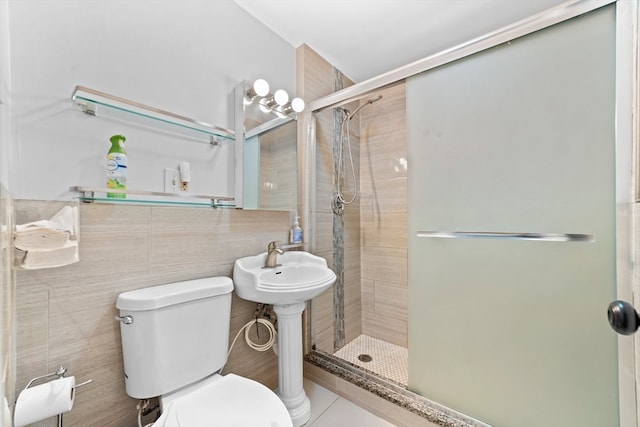 bathroom with tile walls, sink, tile patterned flooring, toilet, and a shower with shower door