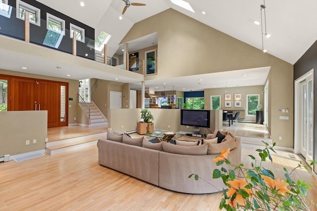 28 Elm St, Berkley, MA 02779 - living room with high vaulted ceiling, wood finished floors, stairway, recessed lighting, and ceiling fan