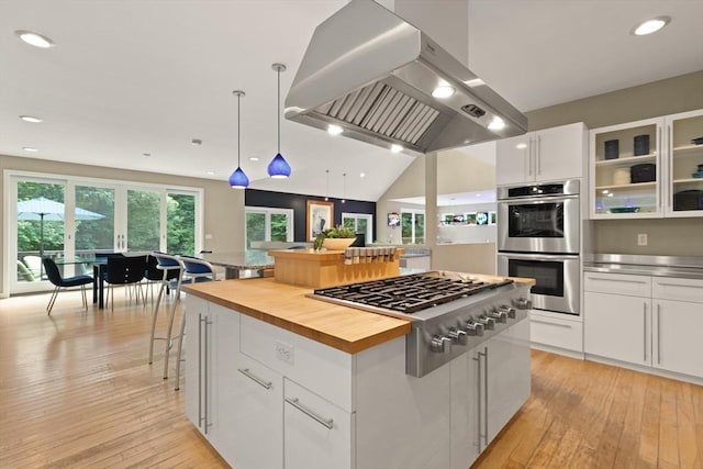 28 Elm St, Berkley, MA 02779 - kitchen with island exhaust hood, stainless steel appliances, white cabinets, light wood-style flooring, and recessed lighting