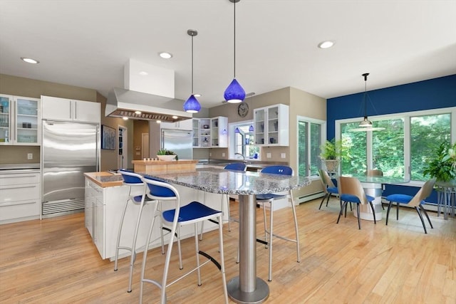 28 Elm St, Berkley, MA 02779 - kitchen featuring stainless steel built in refrigerator, ventilation hood, white cabinetry, a kitchen island, and recessed lighting